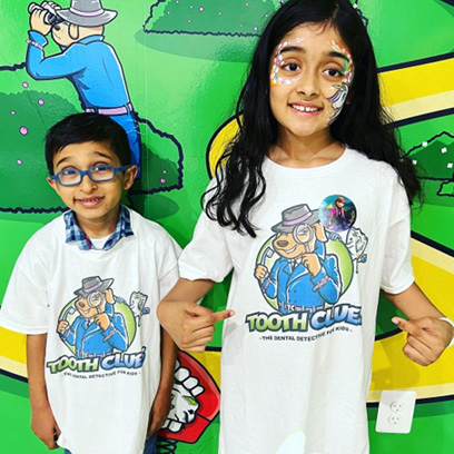 smiling kids wearing Tooth Clues t-shirts